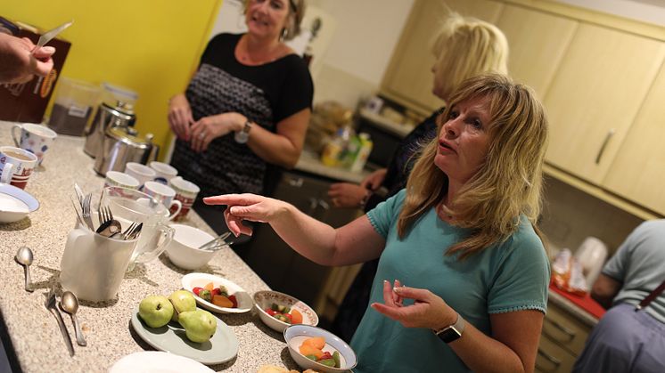 Routes to Roots volunteers helping in the kitchen at a Skinner Street drop-in session
