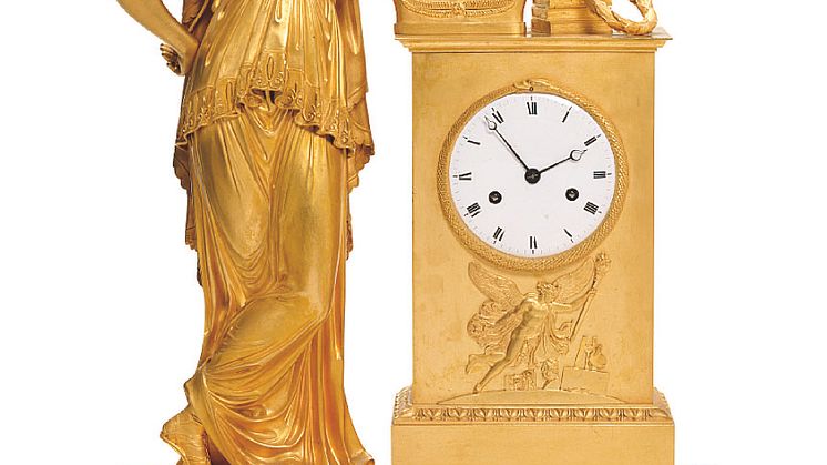 A large French Empire gilt bronze mantel clock