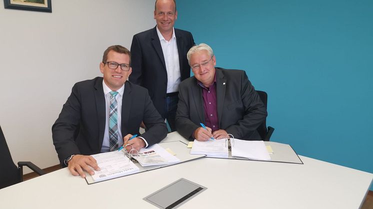 v.l. Bürgermeister Felix Wissel unterzeichnet im Beisein von Mirko Tanjsek und Stefan Teutscher (beide Deutsche Glasfaser) den Vertrag für 20 Glasfaseranschlüsse für die Marktgemeinde Mömbris.