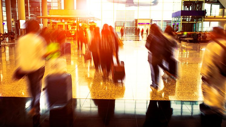32726063-people-with-traveling-luggage-walking-in-airport-terminal