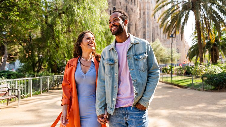 DESR_SPAIN_BARCELONA_SAGRADA-FAMILIA_THEME_COUPLE_HOLDING-HANDS_SMILING-GettyImages-1756019835_Universal_Within usage period_101220.jpg