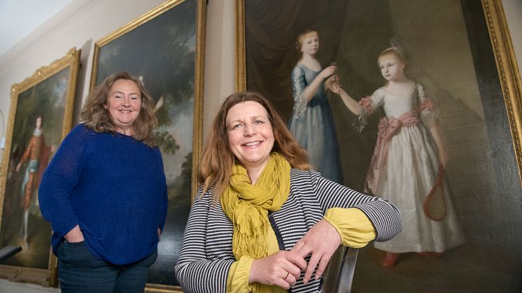 Emma Thomas, General Manager of Seaton Delaval Hall (left); and Nicky Grimaldi, Assistant Professor of Art Conservation at Northumbria University, pictured in front of the portrait of the Delaval sisters.
