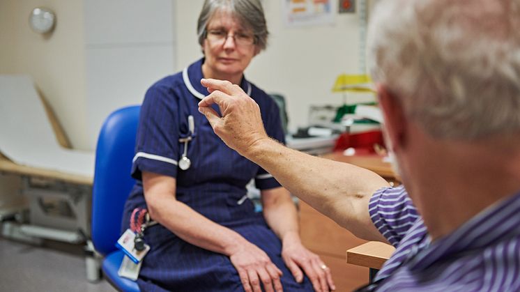 A Parkinson's Nurse working with a patient