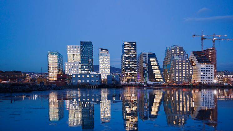 Skyline of Oslo at night reflecting in water