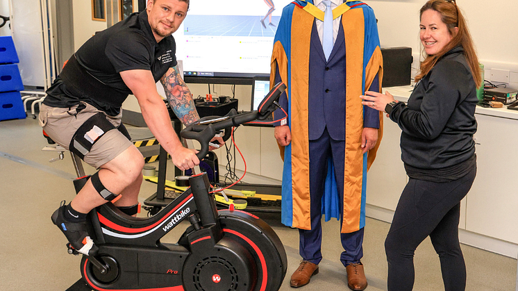 Jon Dutton is given a cycle training system demonstration by Northumbria staff