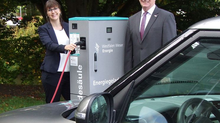 Christiane Rüsel, Kommunalreferentin bei Westfalen Weser, und Bürgermeister Klaus Hülsenbeck testen die E-Ladesäule in Marsberg.