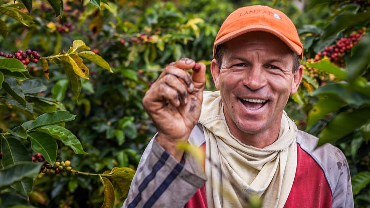 colombian-farmer-showing-a-coffee-cherry_52371621778_o