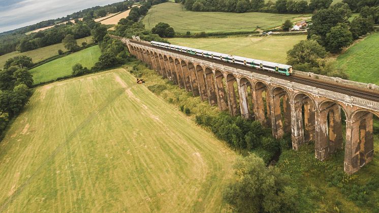 A Southern train cruises over the Ouse Valley Viaduct