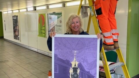 Angie Child with one of the images now on display at Epsom station.jpg
