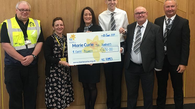 Amanda Casey, Community Fundraiser at Marie Curie receiving their cheque from ng homes staff - Concierge Gerry McDonald, Housing Manager Sharon Hazlett, CSO Alan Nicolson, Chairperson John Thorburn and Concierge & Property Manager Colin Leverage