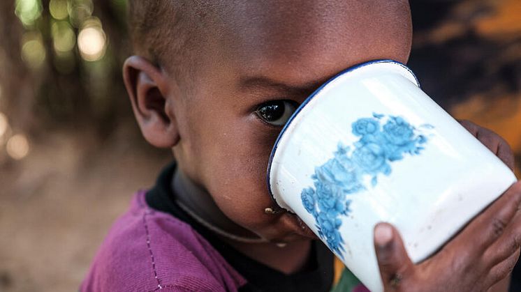 Abdi drinks a cup of milk ,five months after recovering from SAM, at their home, Ethiopia
