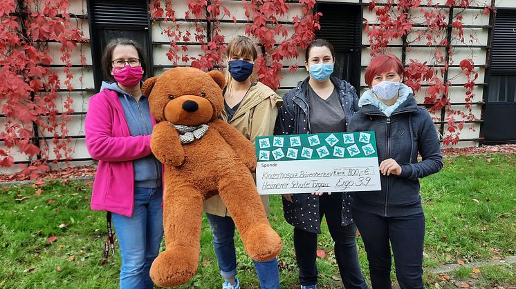 Kerstin Stadler vom Kinderhospiz Bärenherz nimmt den Spendenscheck von Lea Schnellschmidt, Patricia Buttgerereit und Lisa Michaelis entgegen