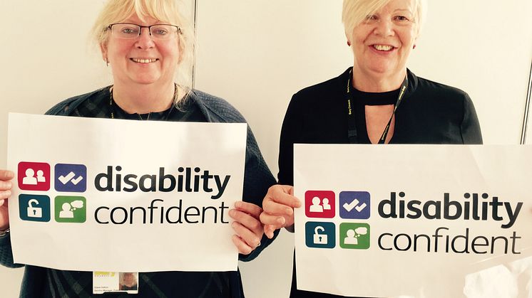 With the accreditation logo are Diane Halton and Cllr Catherine Preston, co-chairs of the council’s disabled employees group.