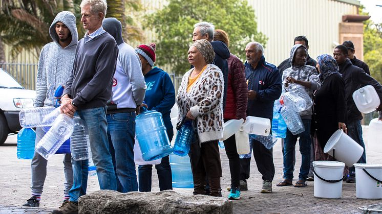 Facing urban water scarcity, Cape Town citizens line up for drinking water during the city's 2018 water crisis (Credit: Cavan / Alamy Stock Photo)