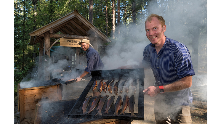 VINNER: Den tradisjonsrike fiskerøykingen på Prestøya vant nylig en avstemning over de mest populære aktivitetene under De nordiske jakt- og fiskedagene. Fiskerøykerne er Håkon Grindal (t.v.) og Erik Burud. Foto: Bård Løken/Anno