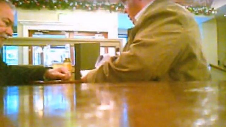 06 Still from covert footage of a meeting