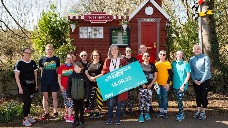 Cllr Debbie Quinn and local running champions, taken at the mock railway station on The Lines at Kirklees Trail in Tottington.
