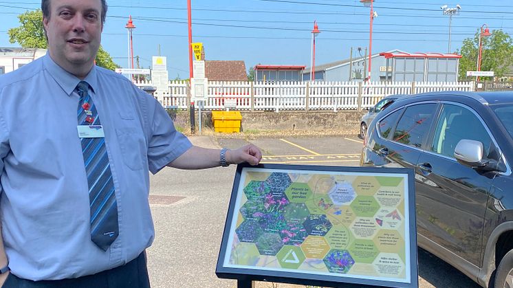Station booking office clerk Darrell Gardiner is delighted with the new bee garden which features this information board (more pictures below)