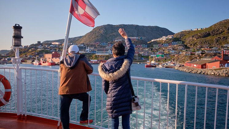 Passengers wave flag Sarfaq Ittuk. Photo - Lisa Germany Visit Greenland