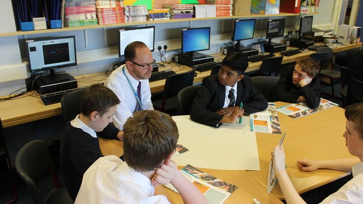 Teacher Mr Smith with S3 pupils at Springburn Academy with the Money Wise textbooks