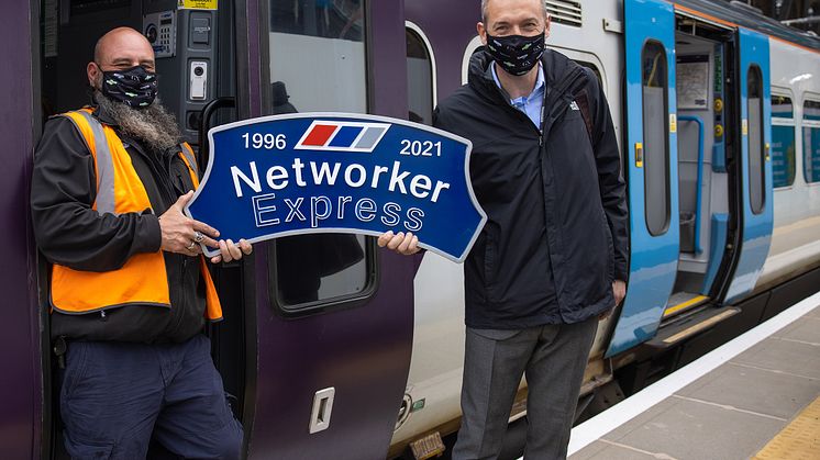 Driver Paul French (left) and Route Operations Assurance Manager Steve Castle proudly hold the headboard ahead of the last Class 365 out of King's Cross