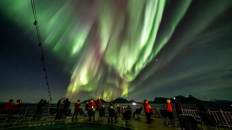 Guests onboard Hurtigruten's Original Coastal Express enjoying the Northern Lights. Photo: Tommy Simonsen