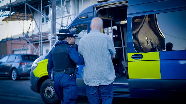 Officers arrest a man on suspicion of violent disorder at an address in Sutton.jpg