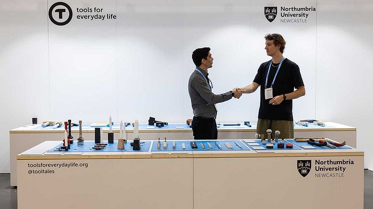 Northumbria Designer in Residence Joe Smith (right) greeting a visitor at the International Furniture Fair in New York