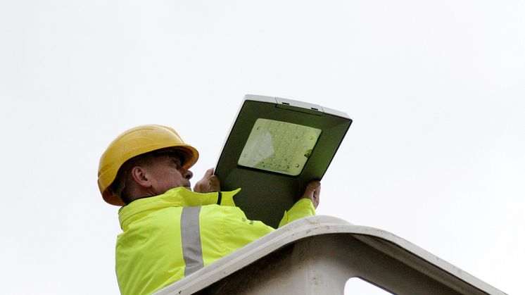 Street lighting supervisor Paul Birchall installs an LED light.