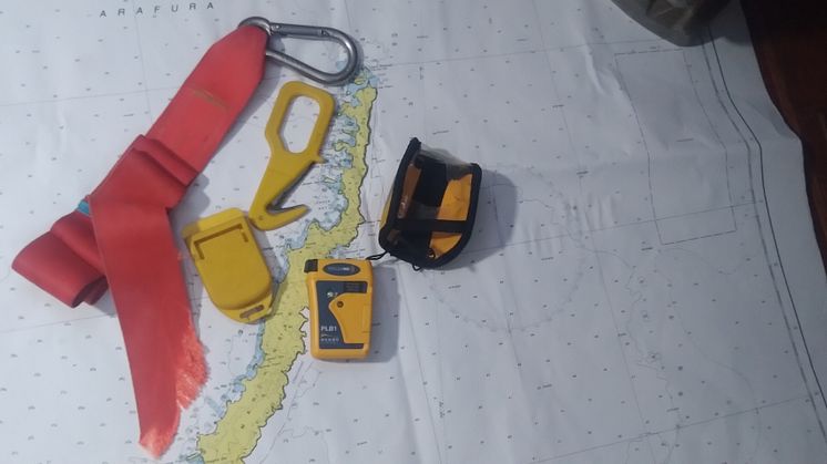 Hi-res image - Ocean Signal - Nigel Fox's equipment - the Ocean Signal rescueME PLB1, alongside the hook knife he used to cut the jack line