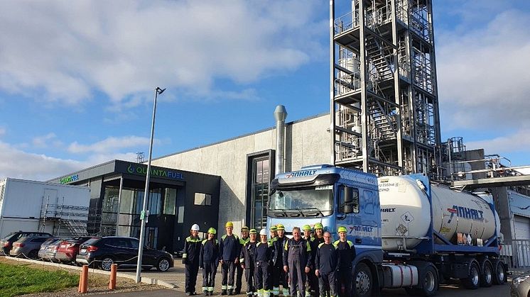 Quantafuel team members at Skive in front of a shipment ready to go to BASF