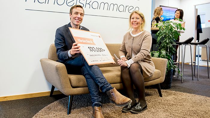 Oskar Axelsson, regionchef på Handelskammaren Mälardalen, tar emot checken på 100 000 kr från bankens VD Cecilia Jeffner.