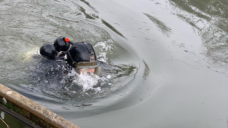 Police diver searching a canal