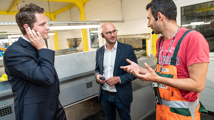 Dr. Thorsten Leopold, Henkel (links) und Sebastian Bayer, dm-Geschäftsführer für Marketing + Beschaffung (Mitte), lassen sich den Verwertungsprozess von Produkten und Verpackungen in der Recycling-Anlage Meilo in Gernsheim zeigen. 