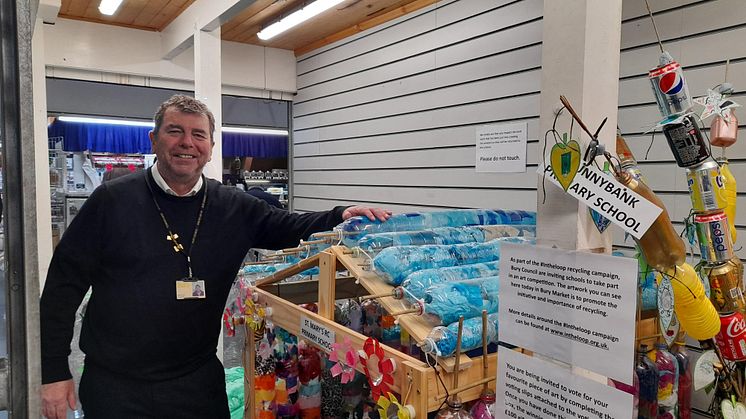 Councillor Alan Quinn, Cabinet Member for Environment, Climate Change and Operations stood with the works of art