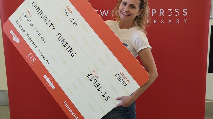 Maria Cook, Chairperson of Autism Support Crawley (left) takes delivery of a 'rail ticket cheque' from Gatwick Express
