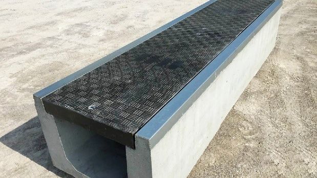 Precast concrete trench systems including Fibrelite covers
