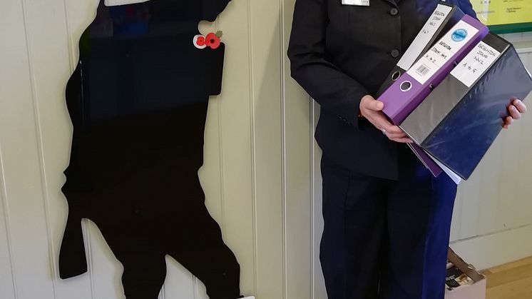 Laura Lee pictured with her research into Brighton railway workers who served in the Great War 