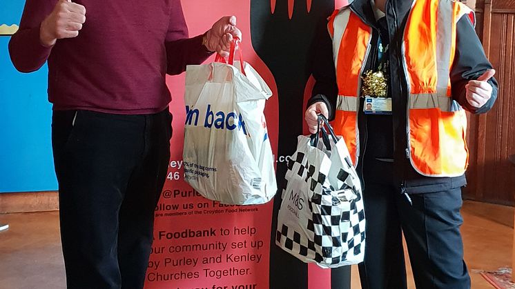 Southern driver Laura McDonald gives food bank administrator Steve Hunt donations for Purley Food Hub