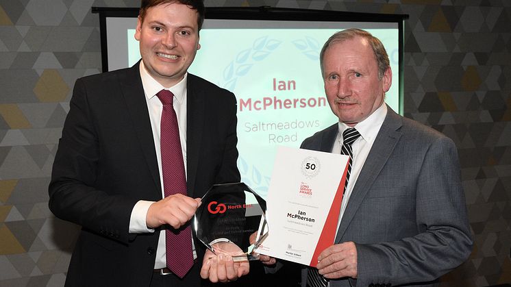 Martijn Gilbert, Go North East managing director, presenting Ian McPherson with his award