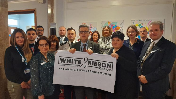 The Community Safety Partnership Board show their support for the White Ribbon campaign