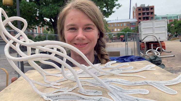 Konstnären Liva Isakson Lundin med en modell av sitt verk som just nu monteras på Stora torg i Eslöv.