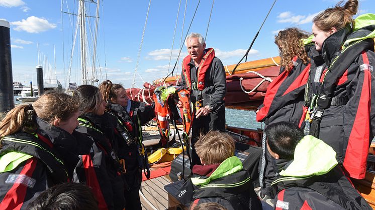 Hi-res image - Ocean Signal - Head of Sailing at Dauntsey’s Toby Marris briefs the Jolie Brise crew about the Ocean Signal rescueME MOB1