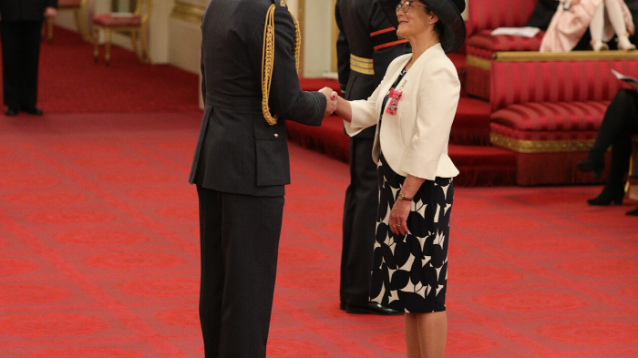 Professor Jane Core recieving her MBE from Duke of Cambridge