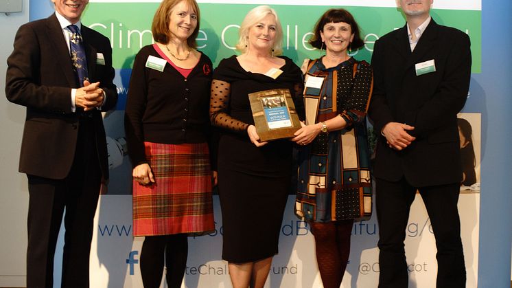 ng homes Regeneration Manager Margaret Fraser (Middle) receives the award from the Climate Challenge Fund Awards Panel.