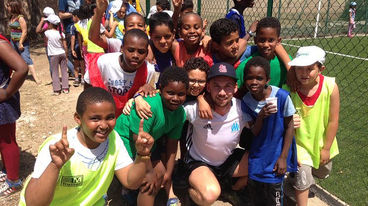 Marco with local children who will benefit from the new community football pitch.