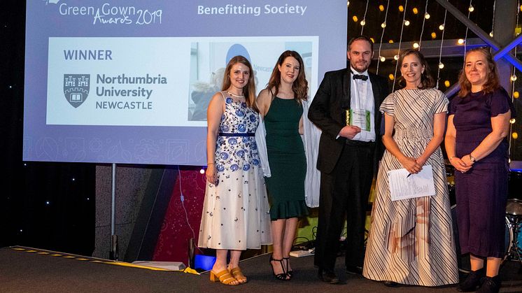 Northumbria's Rachel Dunn, Kayliegh Richardson, Paul McKeown, and Elizabeth Passey receiving the award from the Green Gown host