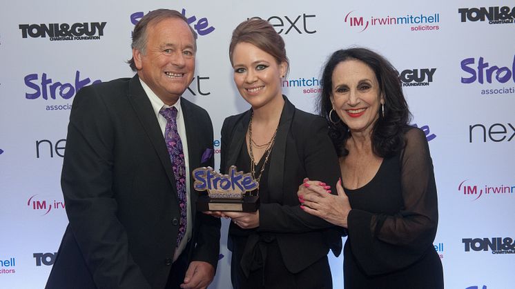 Lily Heinemann from Royal Mail receiving the award from Comedian and stroke survivor Duncan Norvelle and Actress Lesley Joseph.