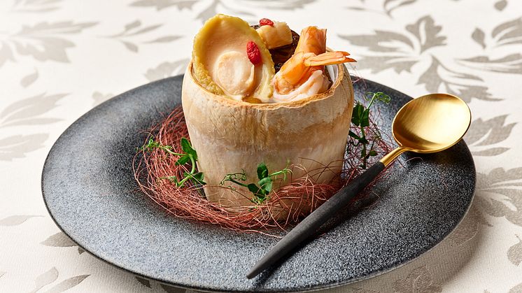 Double-boiled Chicken Soup with Abalone, Dried Scallops, Fresh Prawns and Chinese Mushrooms served in Young Coconut 