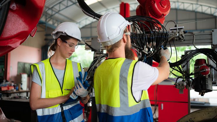 1 Woman and man with robotics - WOSUNA_Shutterstock_2315299093